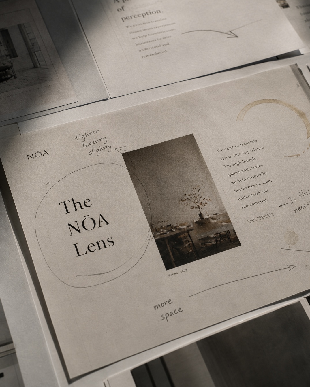 Printed brand references and process notes laid out on a worktable